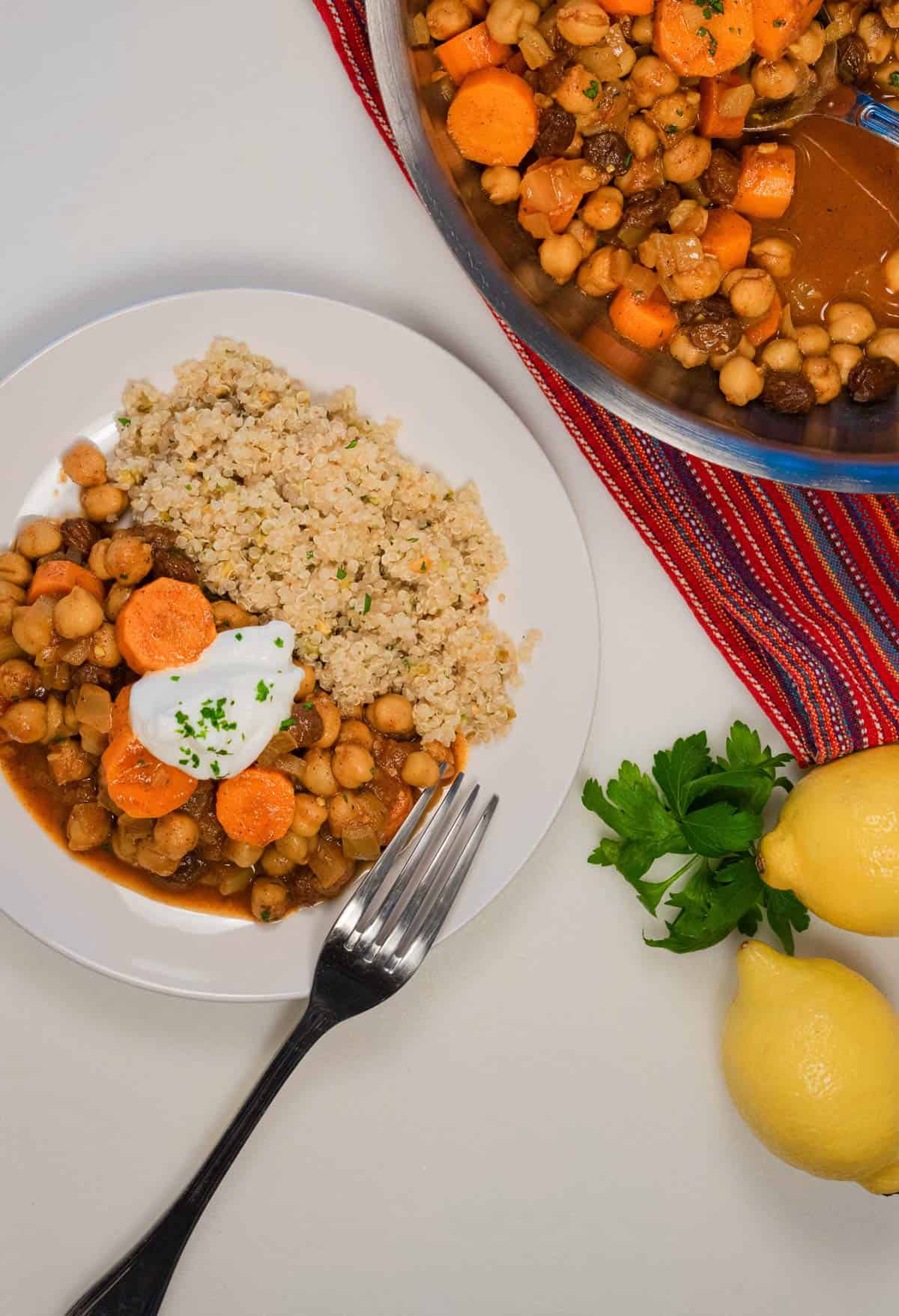Overhead shot of a dish of Moroccan Chickpea Tagine plated with a fork
