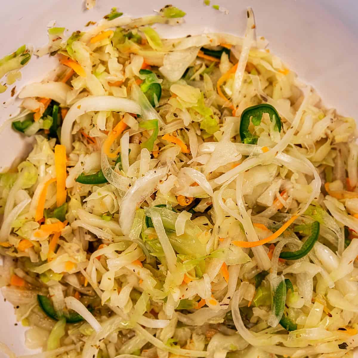 Cabbage, carrots, onions, and jalapenos marinating in vinegar.
