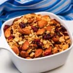 Bowl of granola with almonds and cranberries.