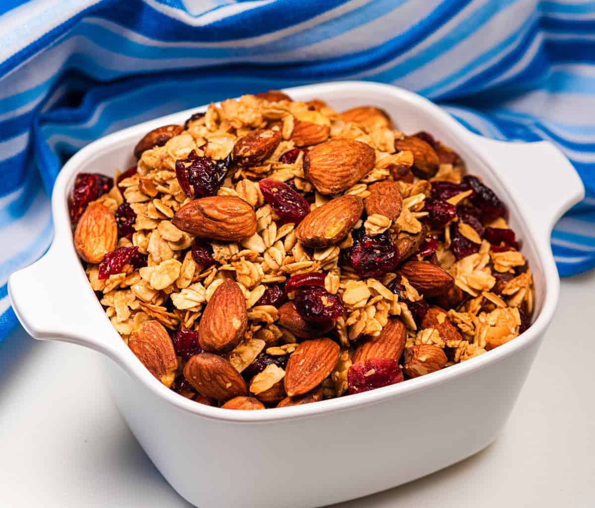Bowl of cranberry coconut granola with almonds and cranberries.
