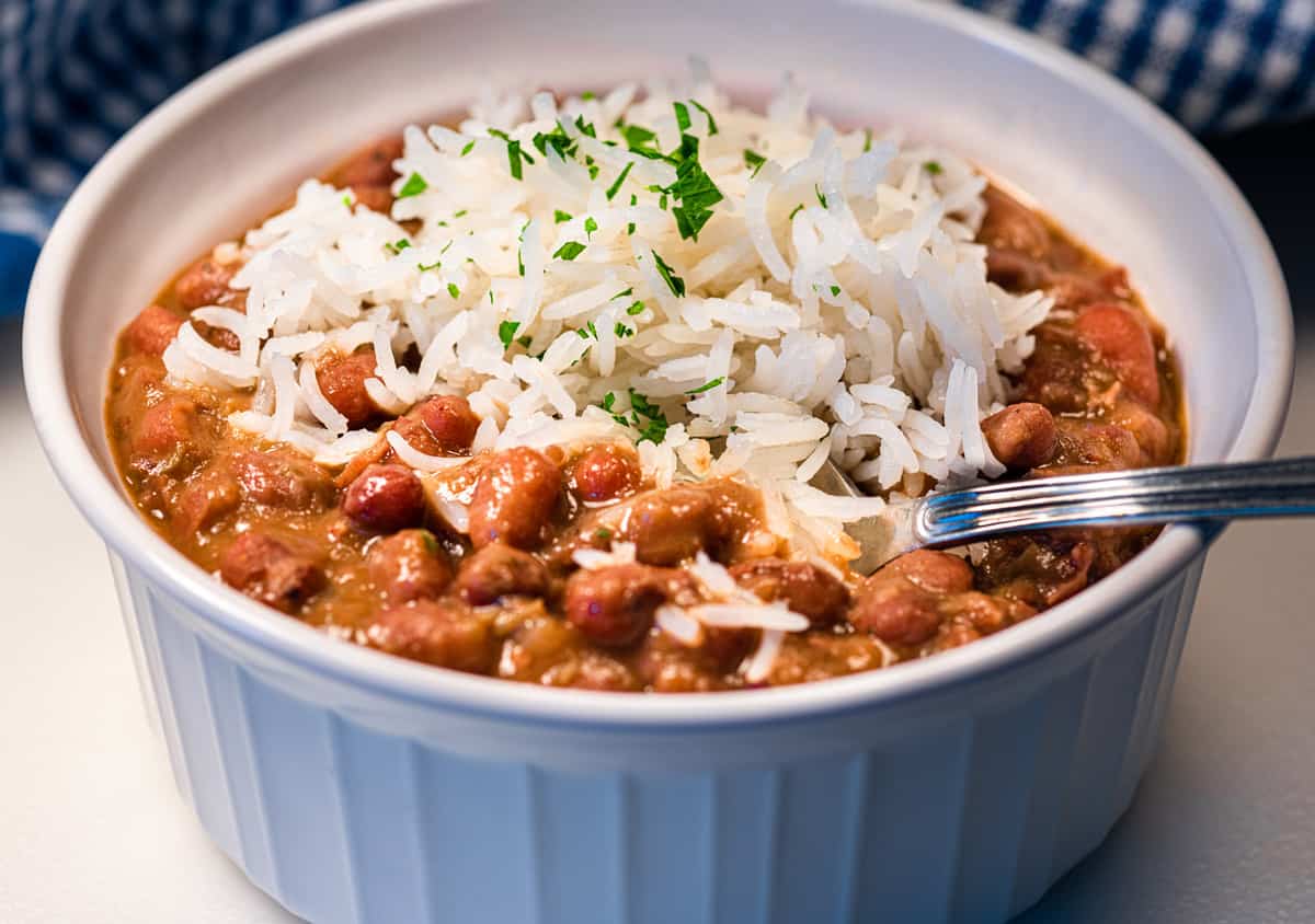 Bowl of red beans and rice with a spoon in it.