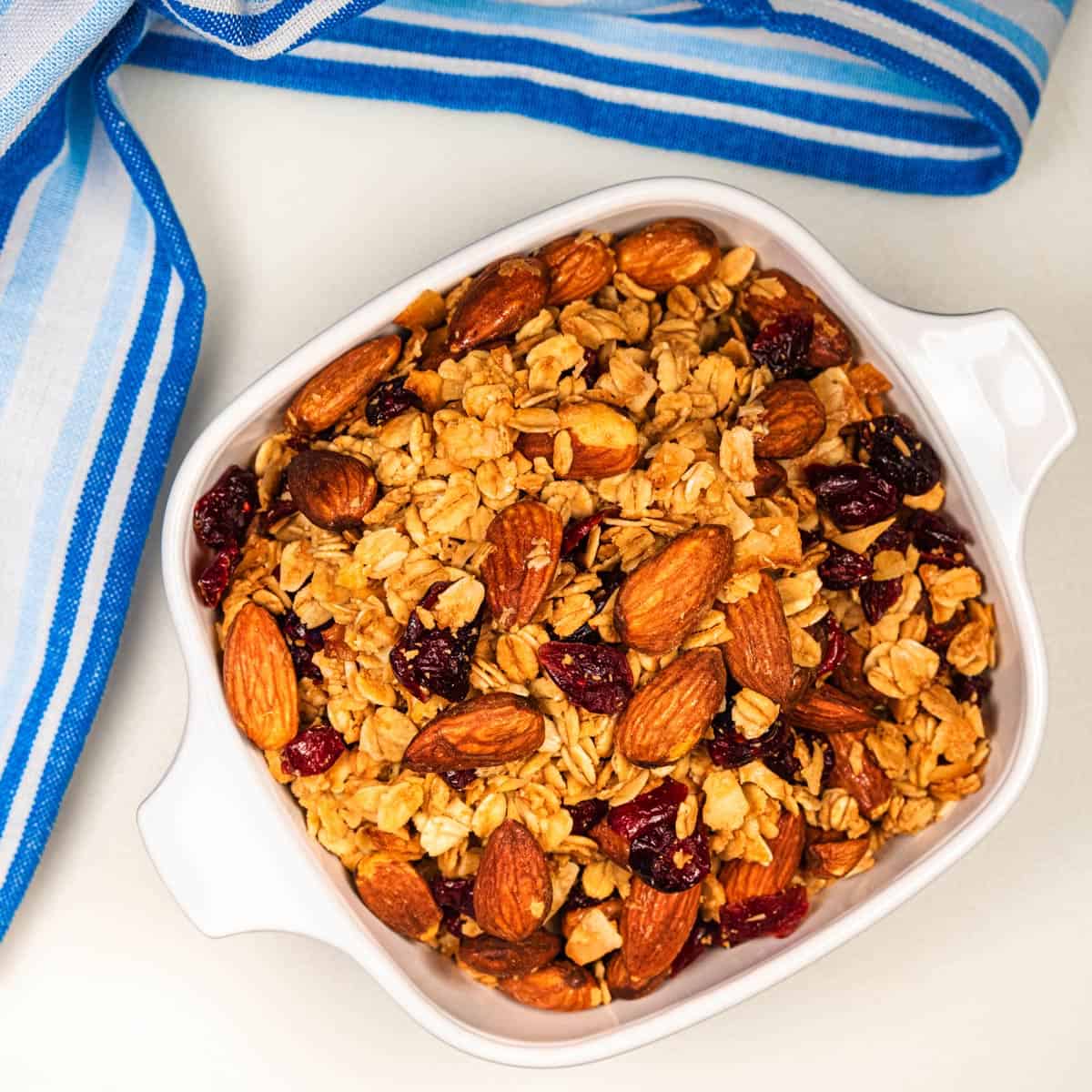 Bowl of vanilla cranberry coconut granola with almonds and cranberries.