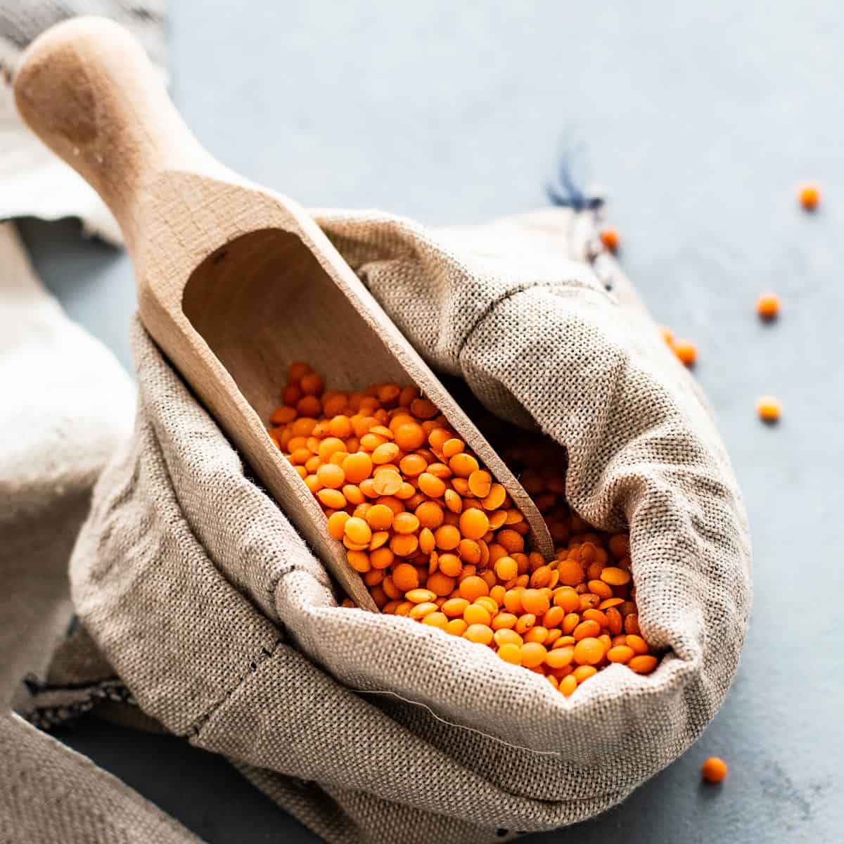 A sack full of uncooked red lentils.