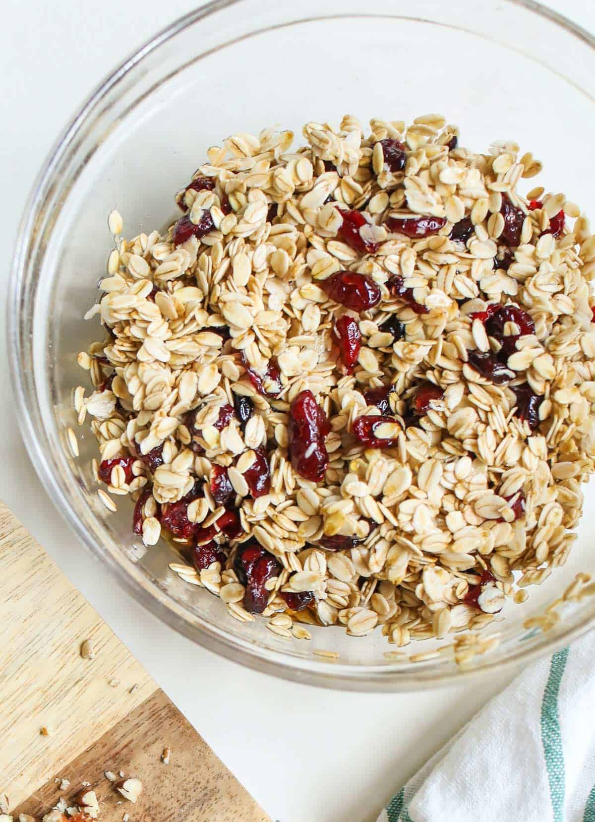 A bowl of raw oats and dried cranberries.