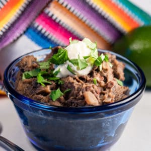 Dish of refried black beans.