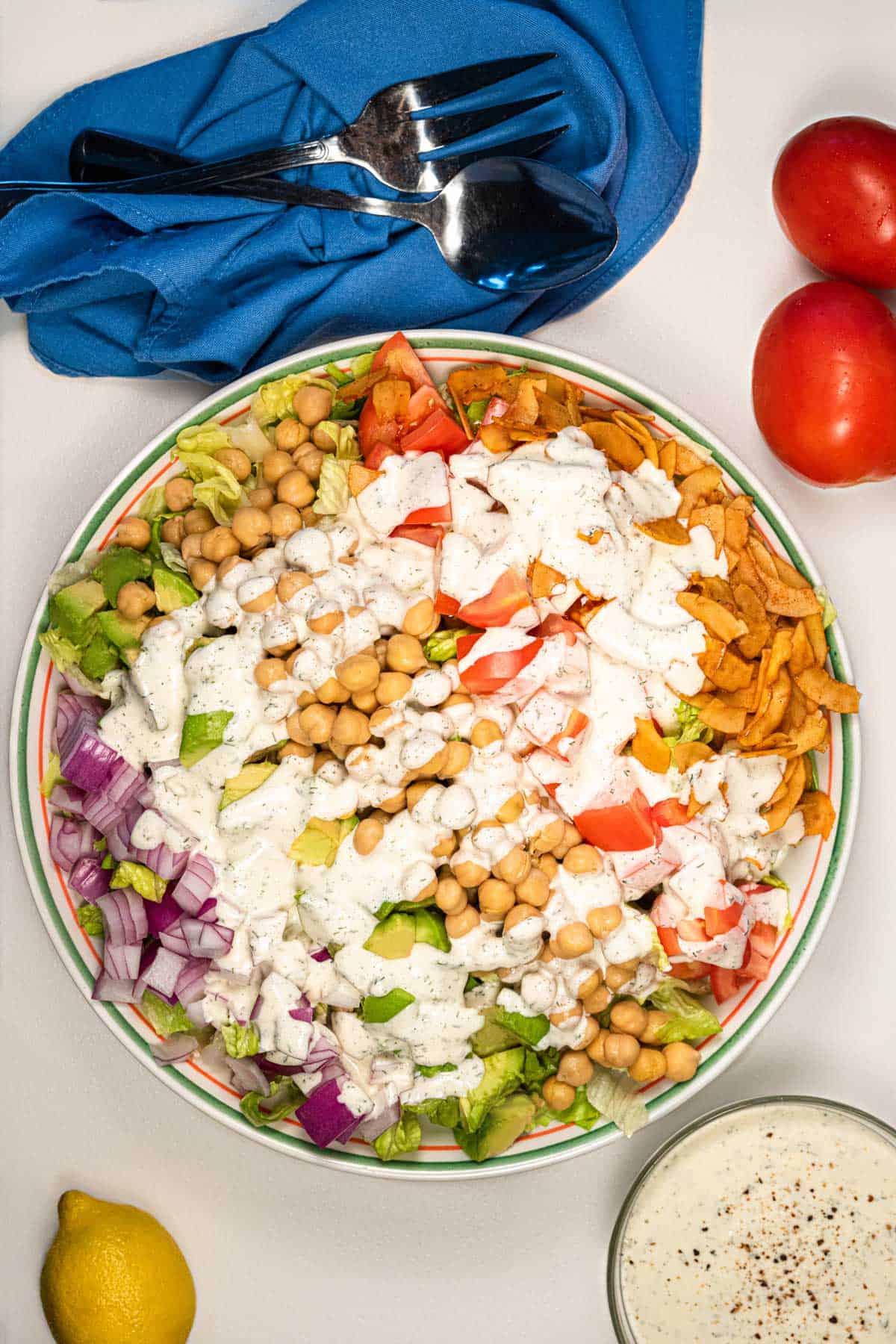 Vegan cobb salad in a serving dish with vegan ranch on top.