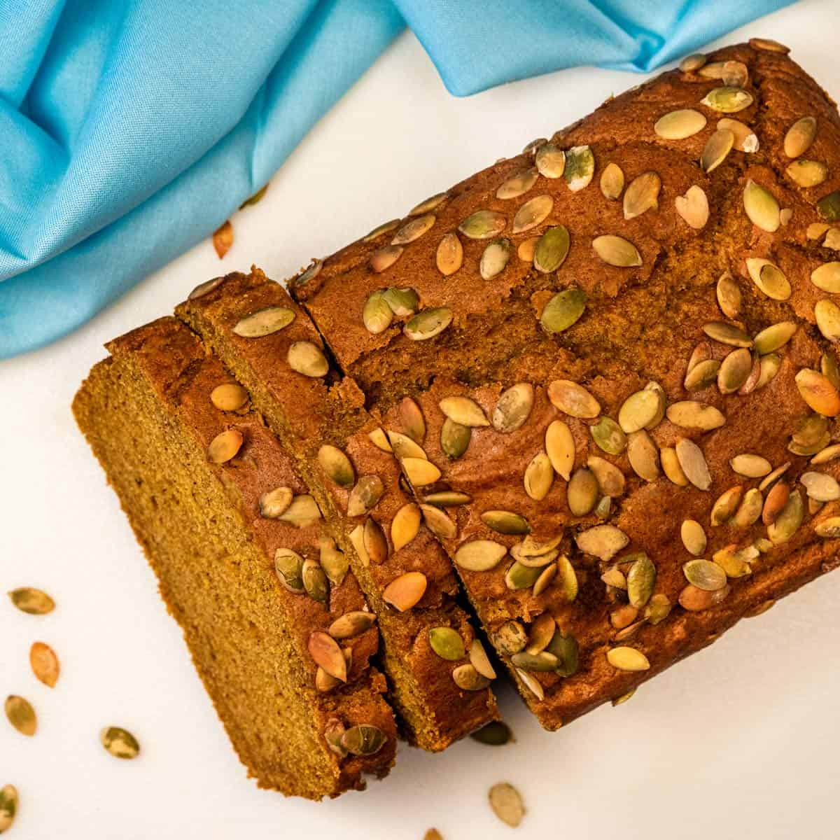 Overhead view of vegan pumpkin bread on a white counter.
