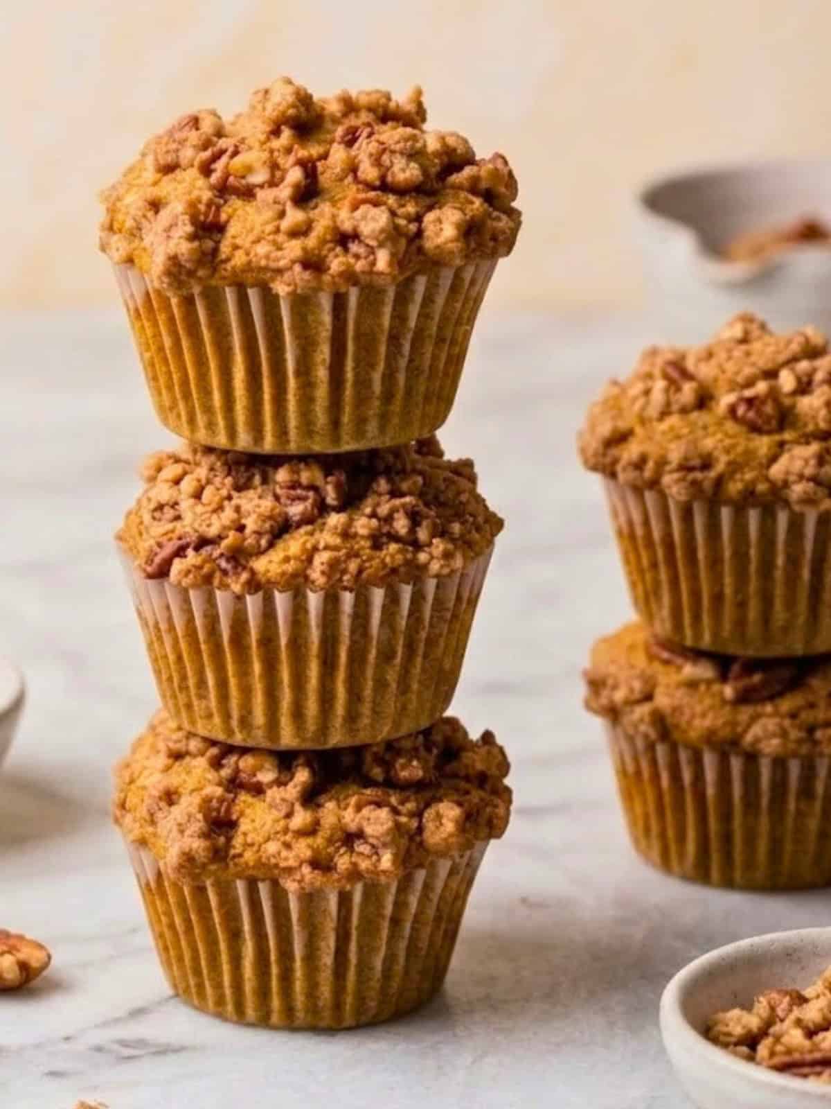 Stack of vegan pumpkin muffins on a marble countertop