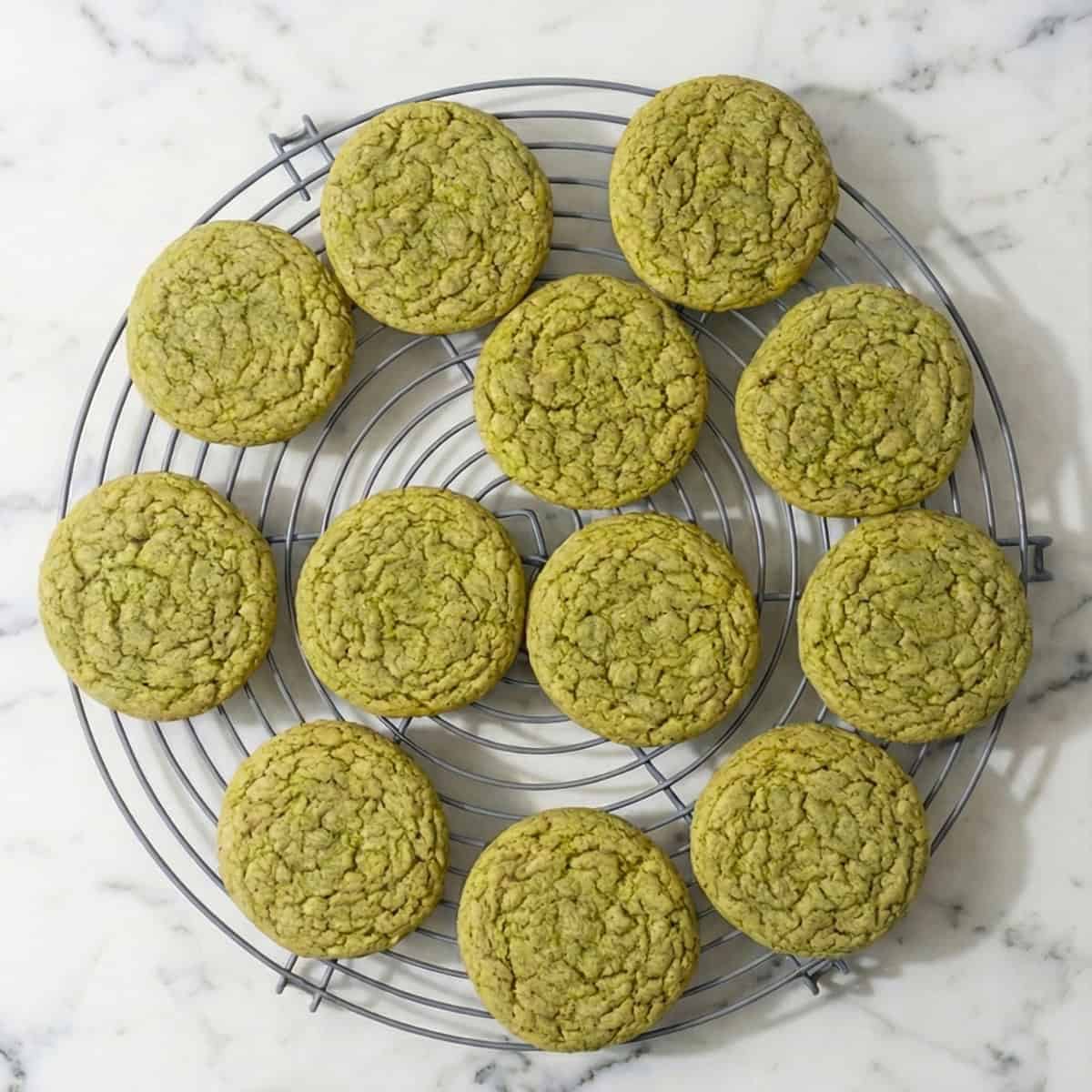 Green matcha cookies on a cooling rack.