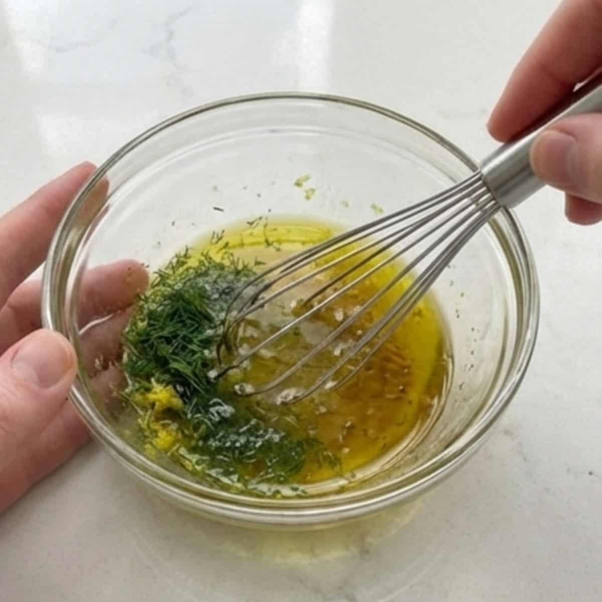 Lemon dill dressing being whisked