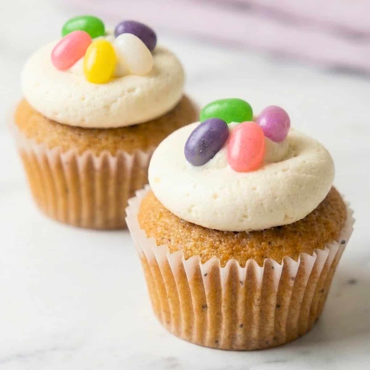 Two vegan Easter cupcakes with jelly beans.