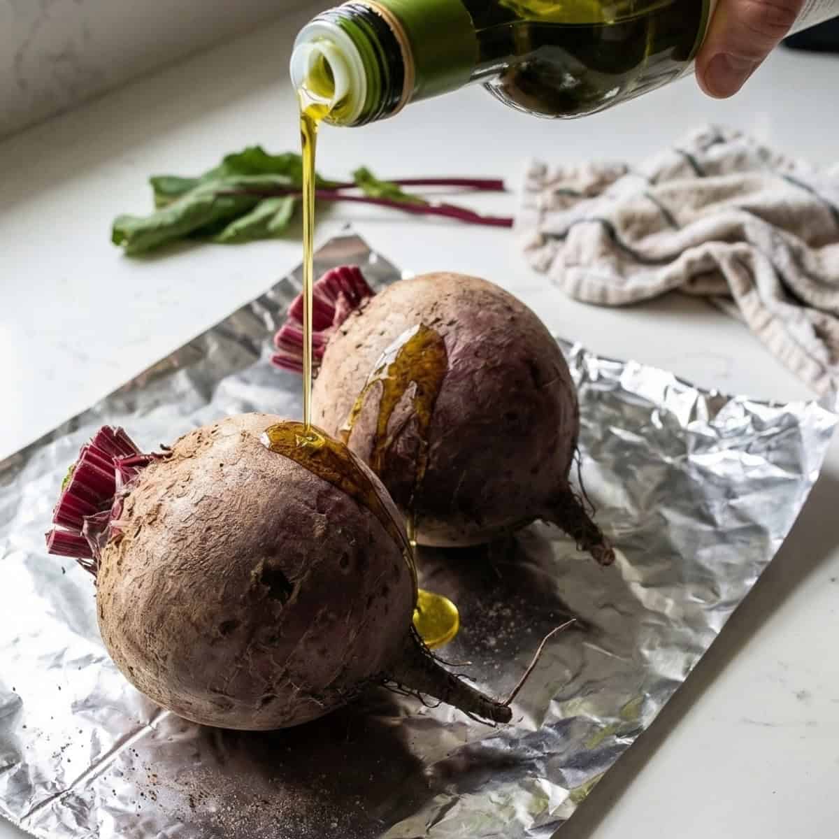 raw beets being covered in oil