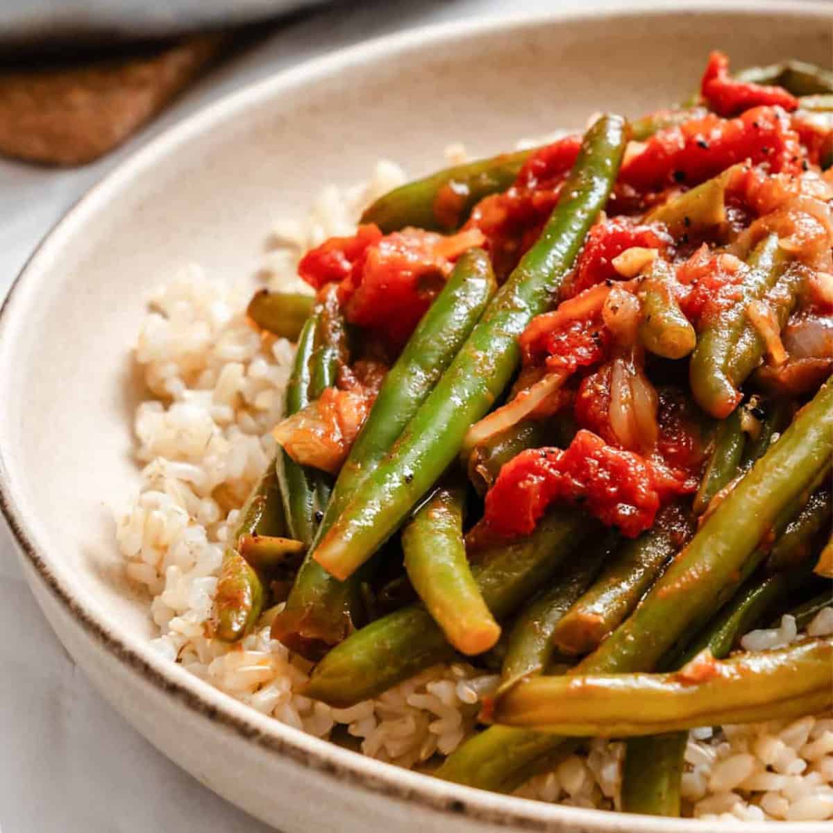 A dish of lebanese green beans over rice.