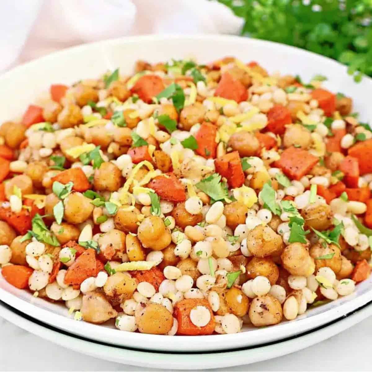 A serving dish of baharat chickpea couscous.