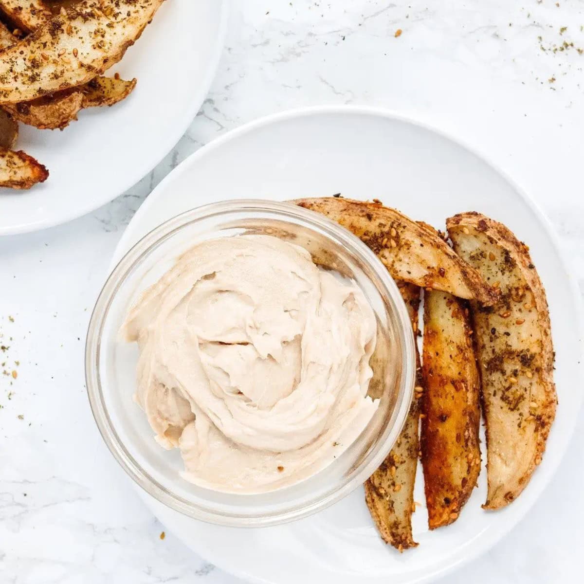 A serving of zaatar fries with tahini sauce.