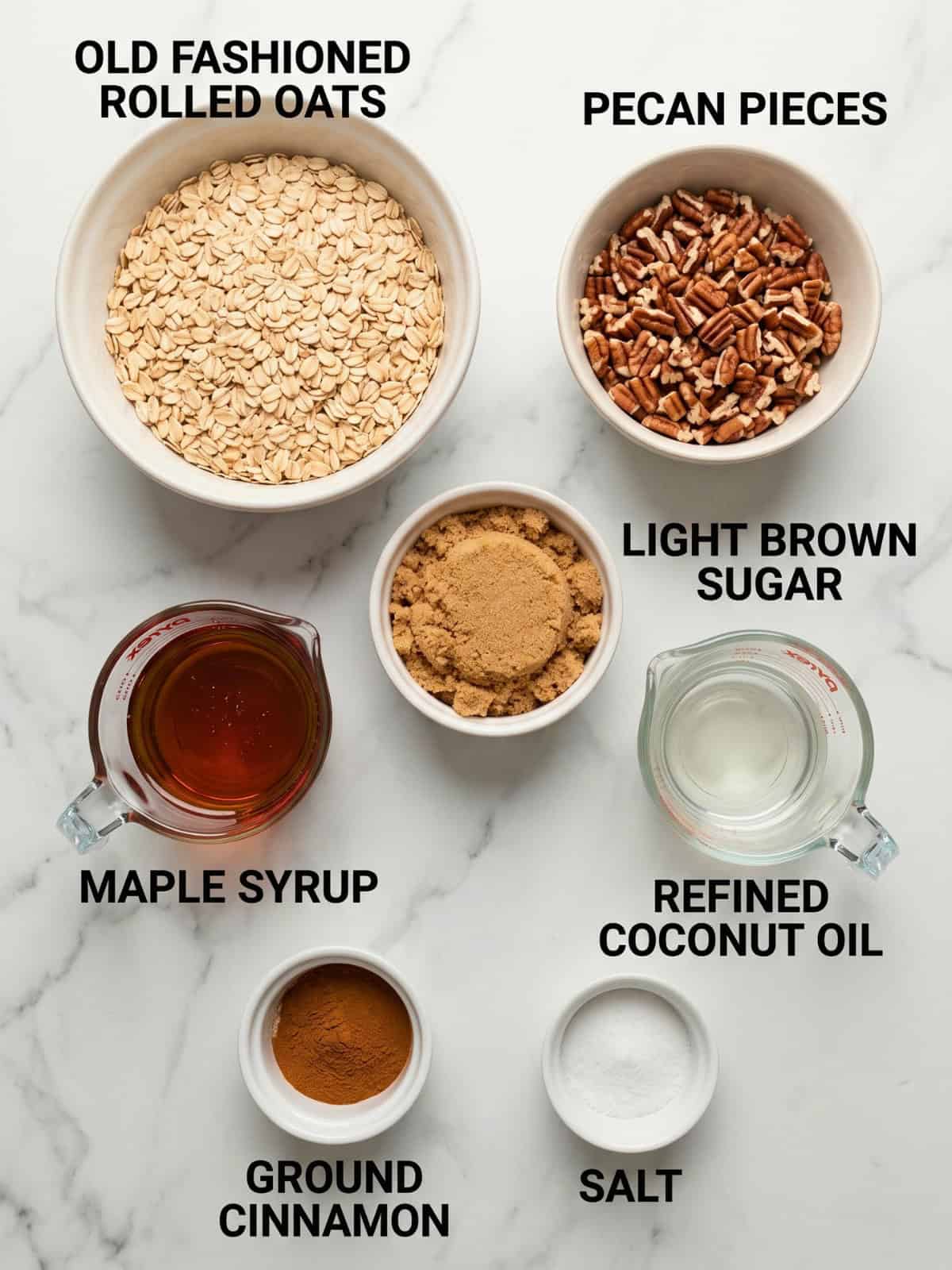 Ingredients for homemade maple pecan granola, including rolled oats, pecans, maple syrup, brown sugar, coconut oil, cinnamon, and salt.